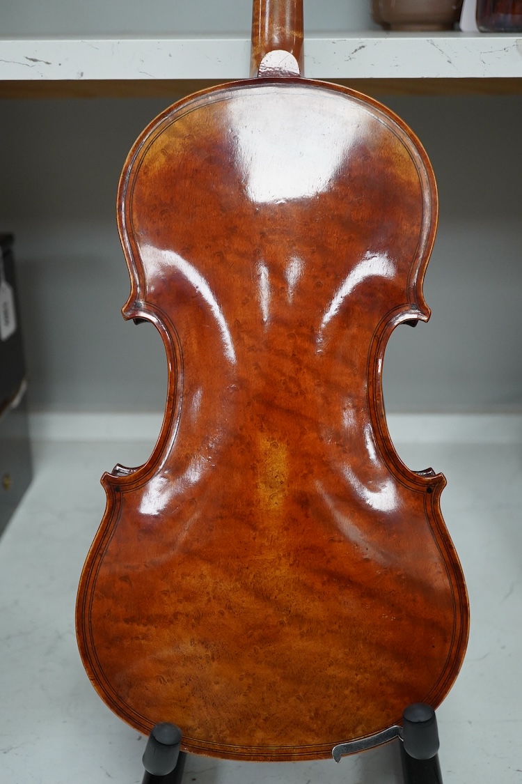 A late 19th century German violin after Pablo Maggini in bird’s eye maple with a fully mounted German bow in a crocodile skin case with retailers ivorine label reading; ‘Edward Withers, 22 Wardour Street, phone City 1899